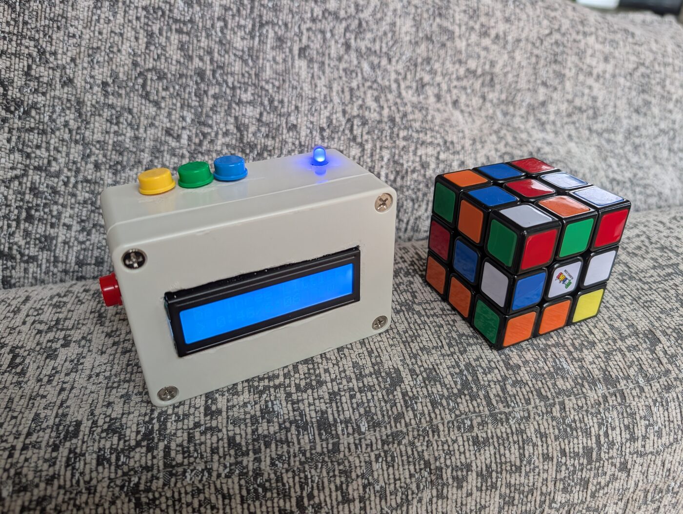 The box next to a Rubik's cube, roughly the same size.